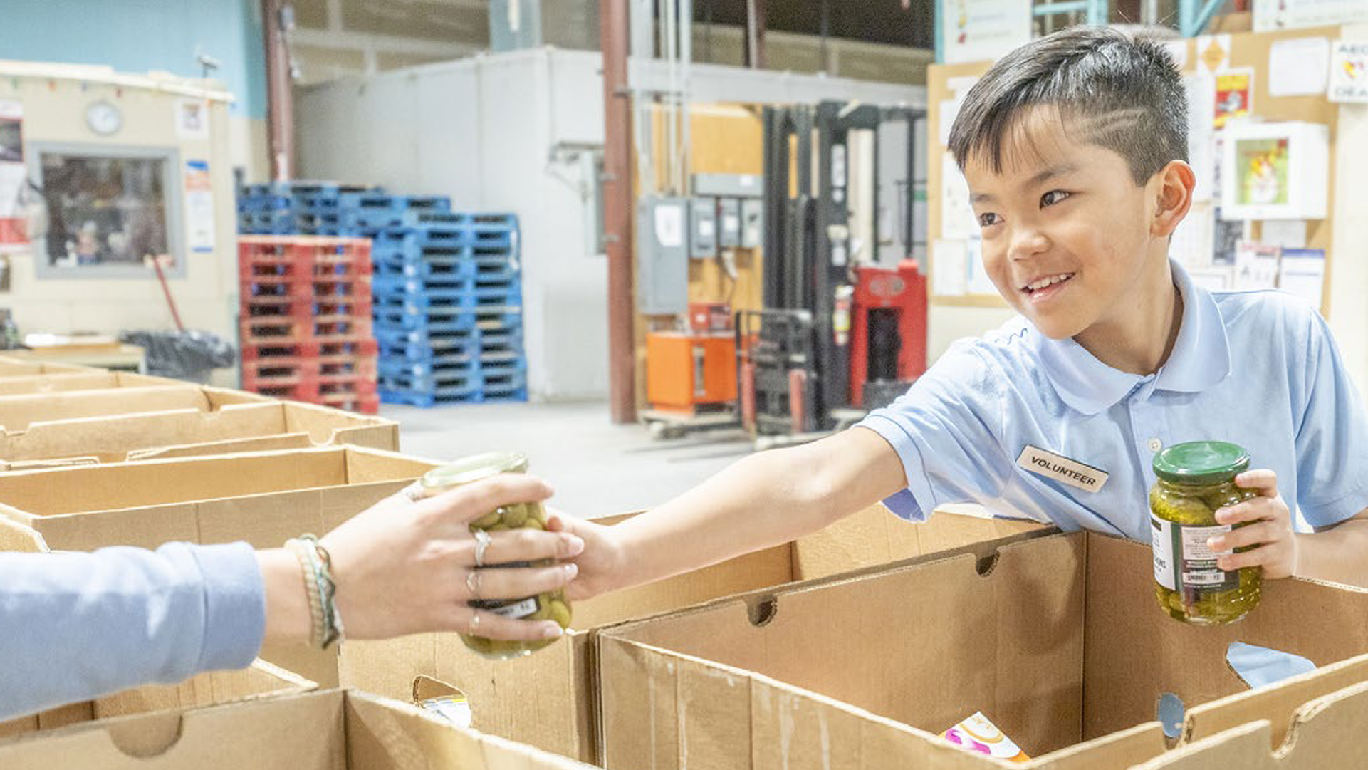 Boy helping package food donations