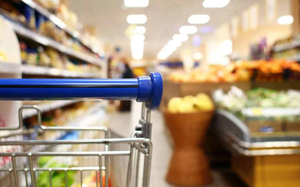 Shopping cart in the produce aisle of a supermarket